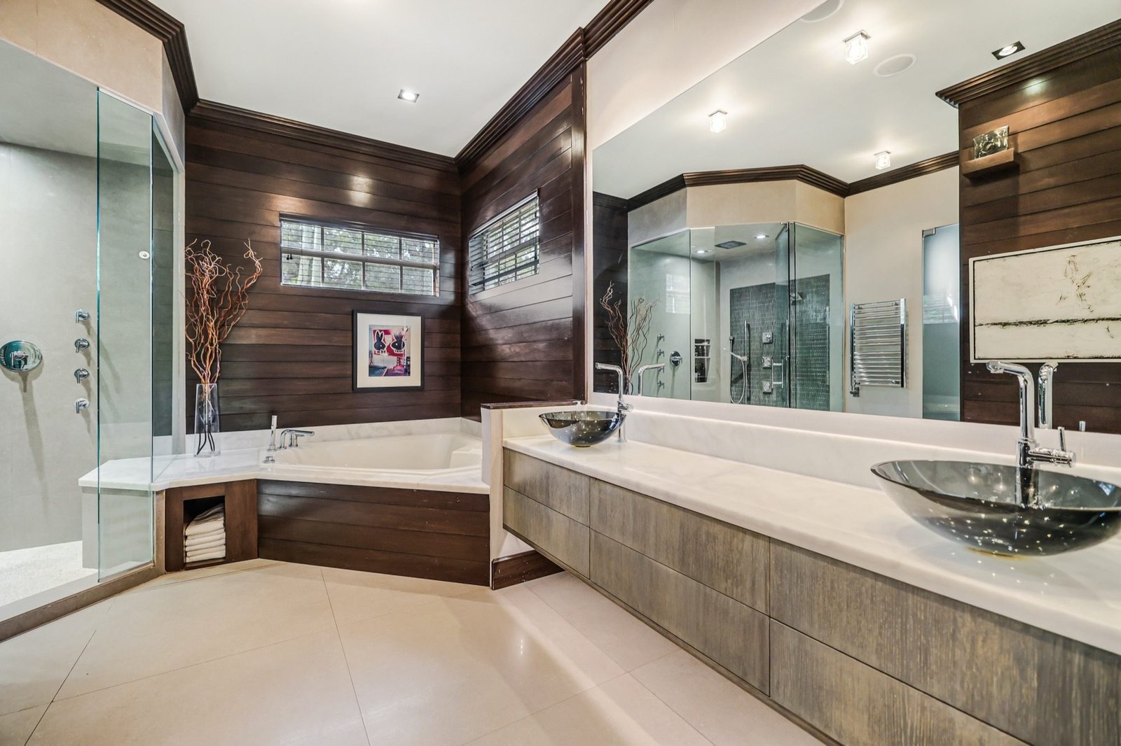 Primary bath with dark timber walls, twin vessel basins and a soaking tub