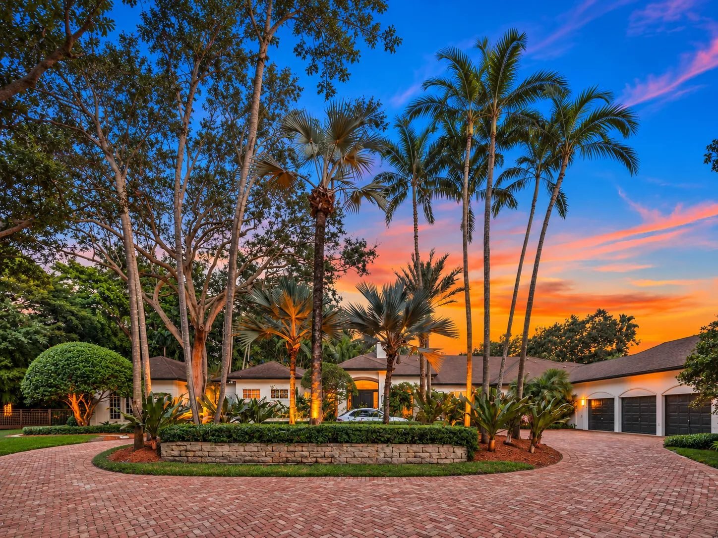 9325 SW 59th Place at twilight, seen across the circular brick driveway