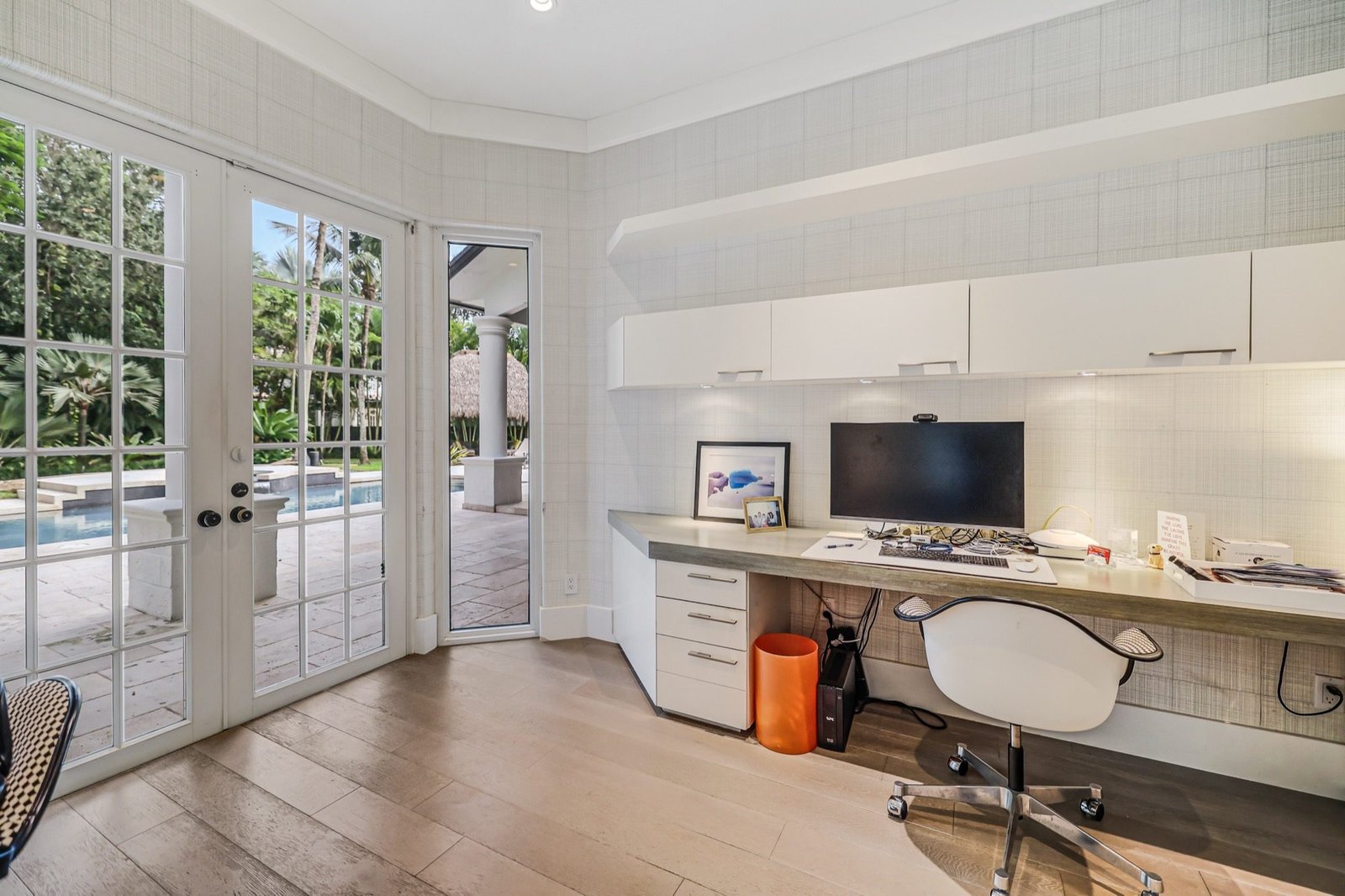 Study with built-in desk and french doors to the pool