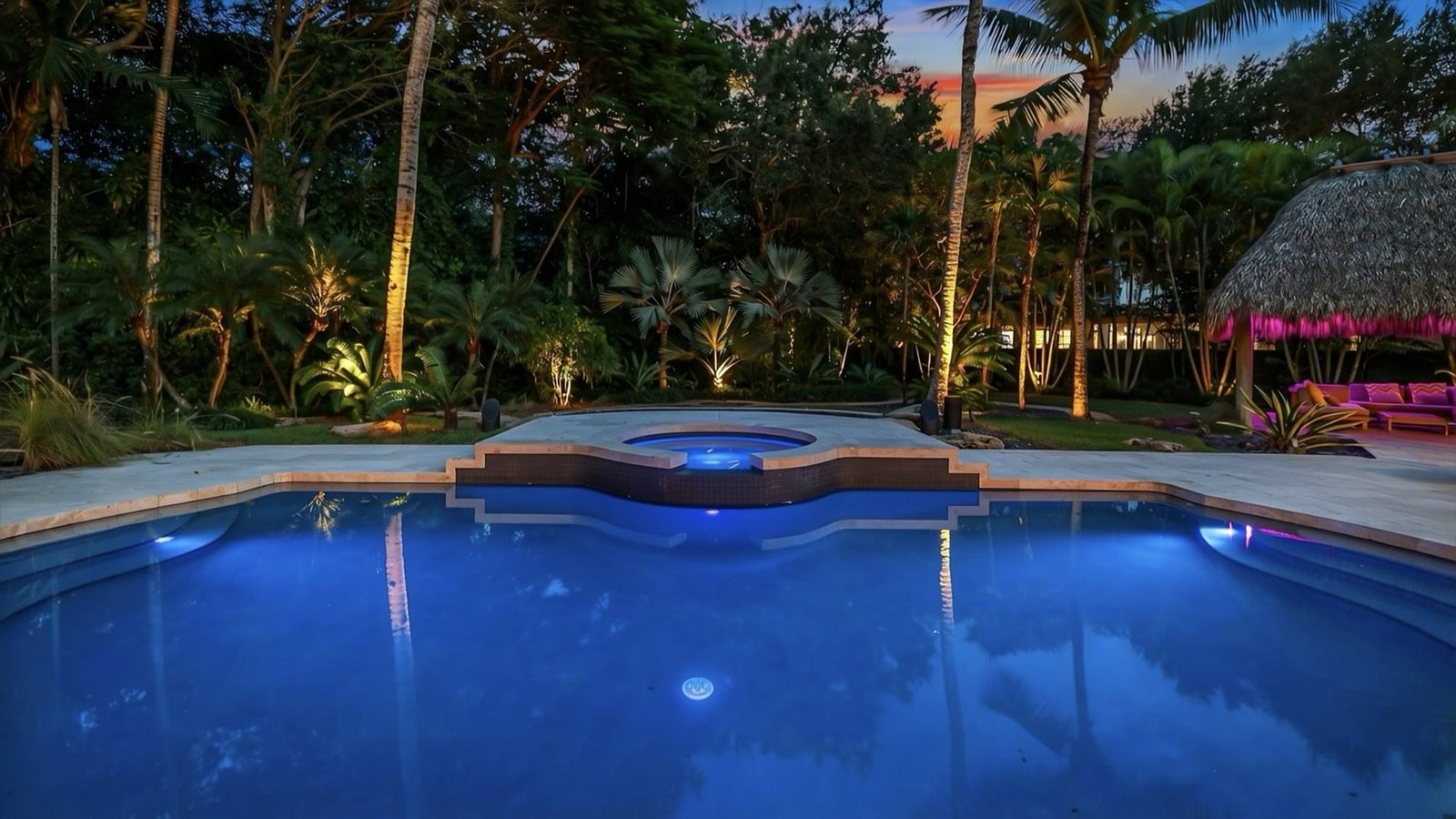 The pool and waterfall spa seen from the far end of the garden