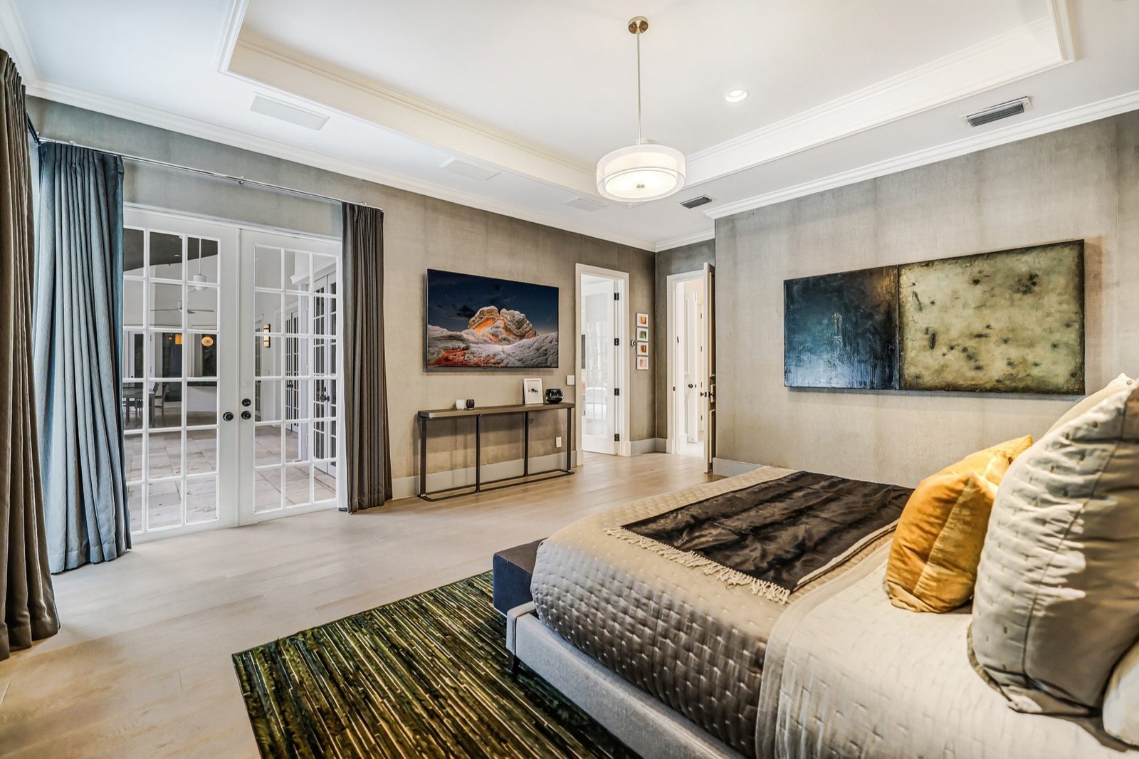 Primary bedroom with french doors to the covered terrace