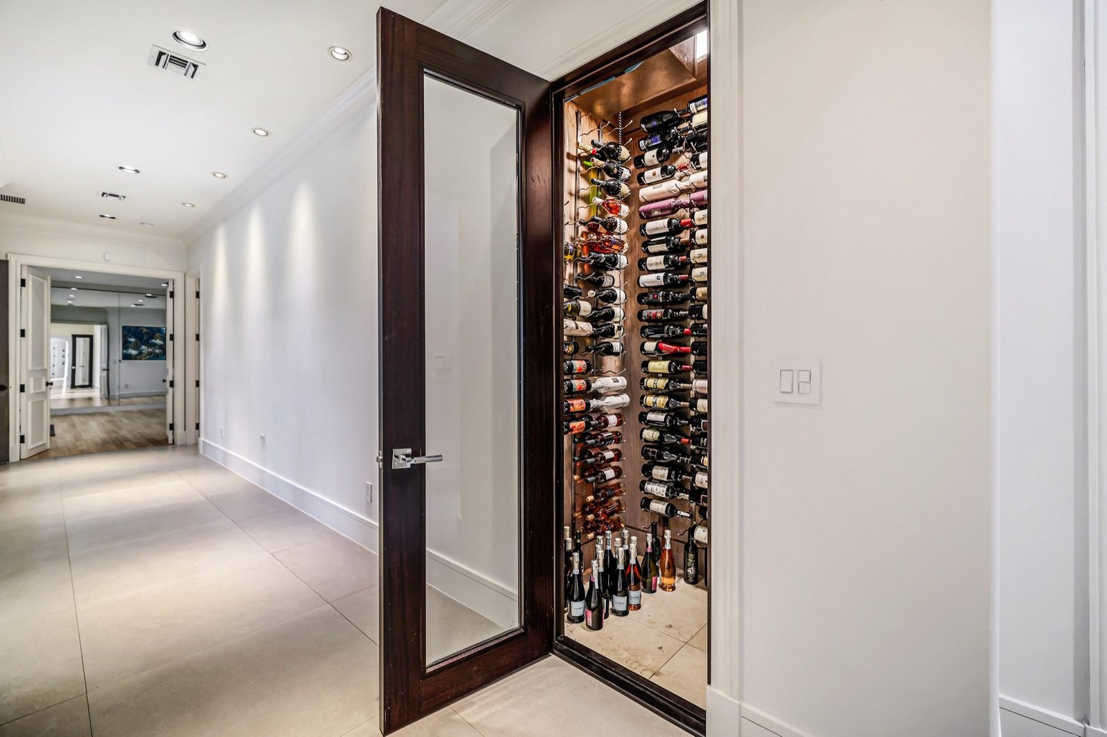 The 300-bottle wine room behind a glazed door off the hallway